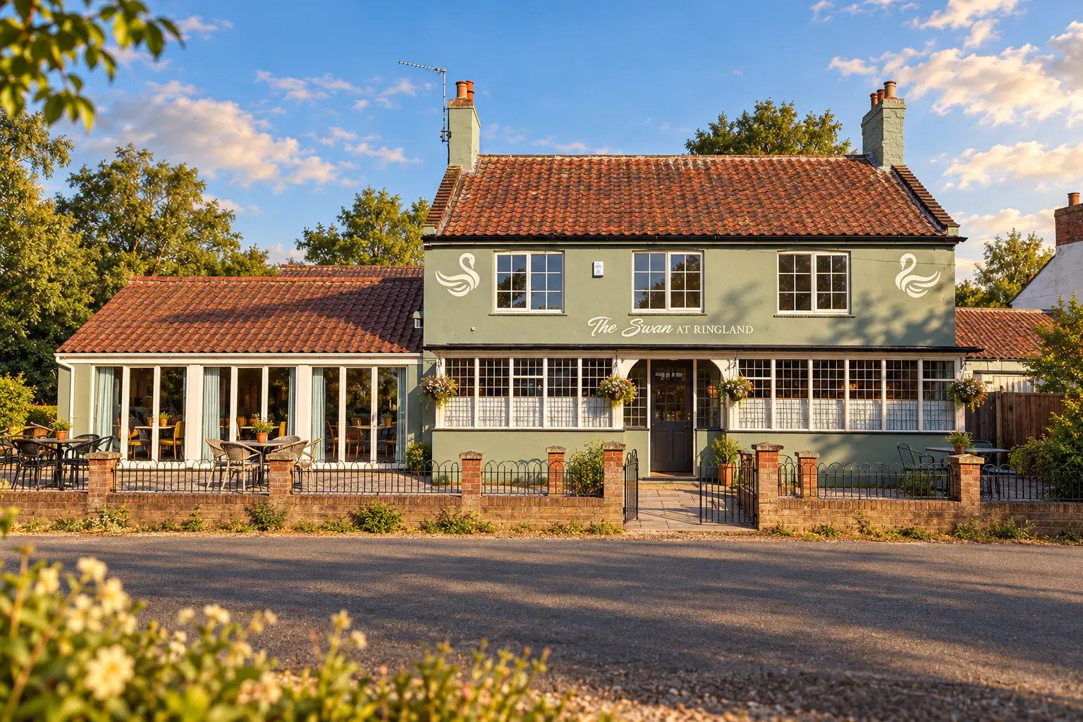AI exterior illustration based on The Swan at Ringland’s official current photograph: its sage-green frontage, weathered red-tile roof, white swan emblems, multi-pane windows, central arched doorway, glazed dining wing and roadside terrace. Not an actual photograph of the premises or guests.